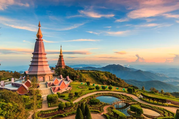 Golden temple overlooking mountains in Thailand at sunrise