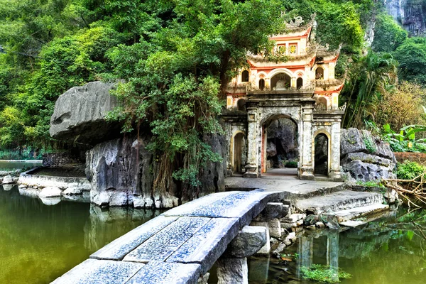Historic temple on a lake surrounded by lush greenery in Vietnam